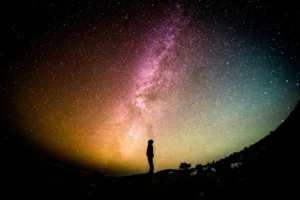 a person stands against a night sky